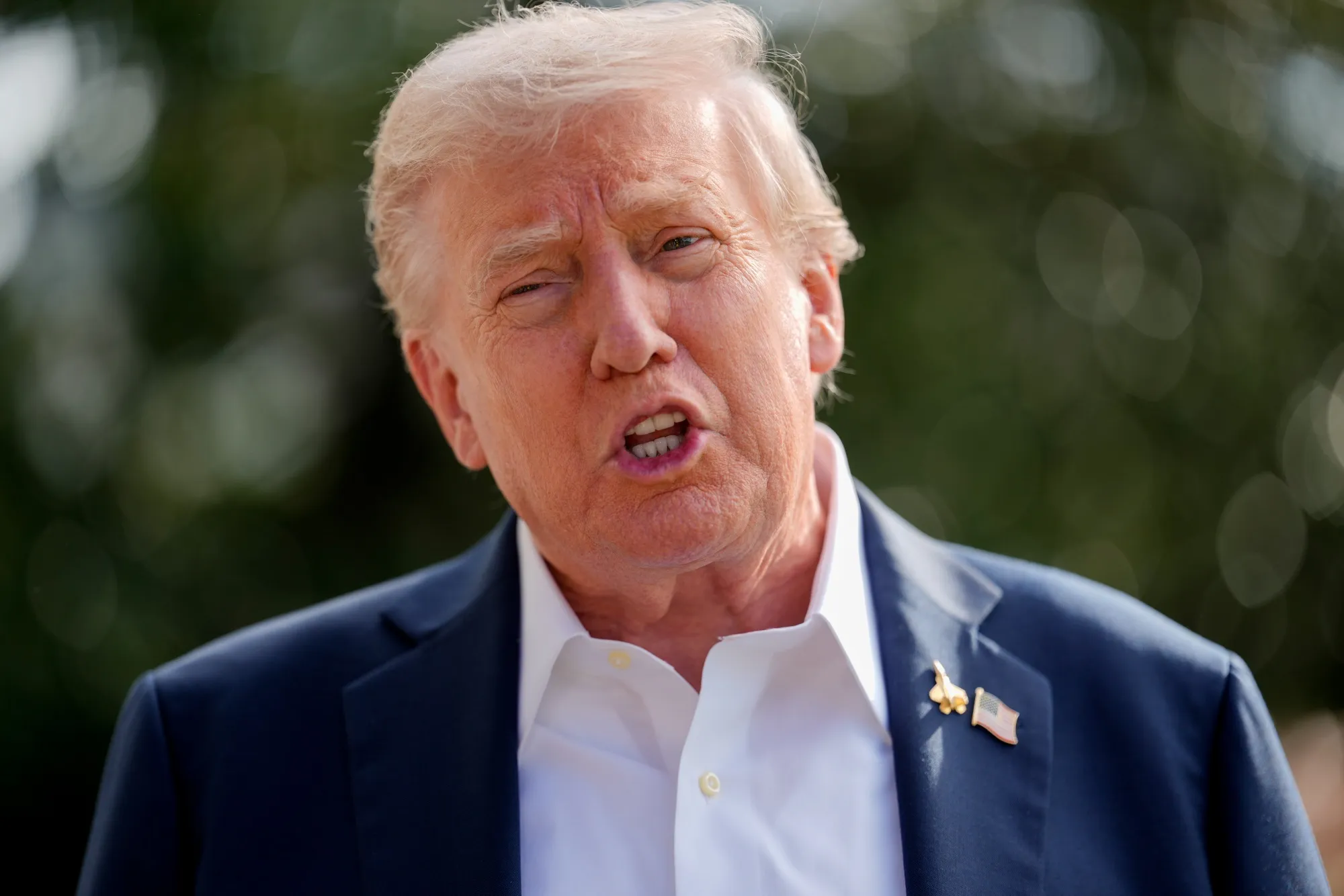 President Donald Trump speaks to members of the media on the South Lawn of the White House on Sept. 26.