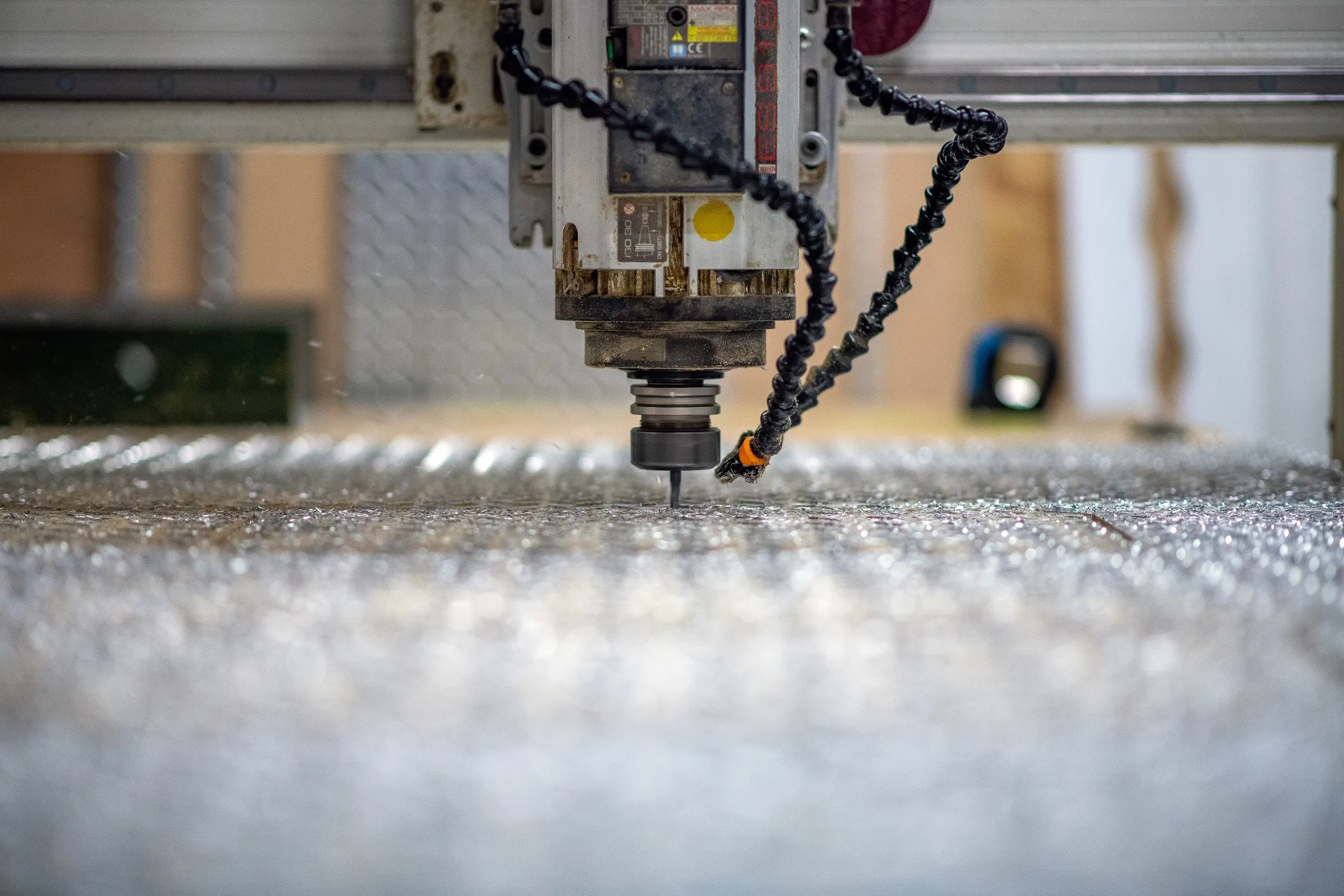A CNC machine cuts a&nbsp;diamond plate metal.&nbsp;
