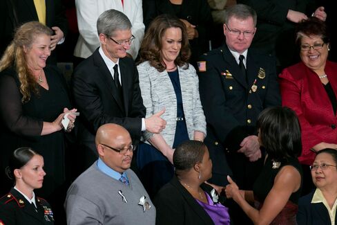 Tim Cook gestures to U.S. First Lady Michelle Obama before President Obama delivers the State of the Union address to a joint session of Congress in Washington, D.C. on Feb. 12, 2013.