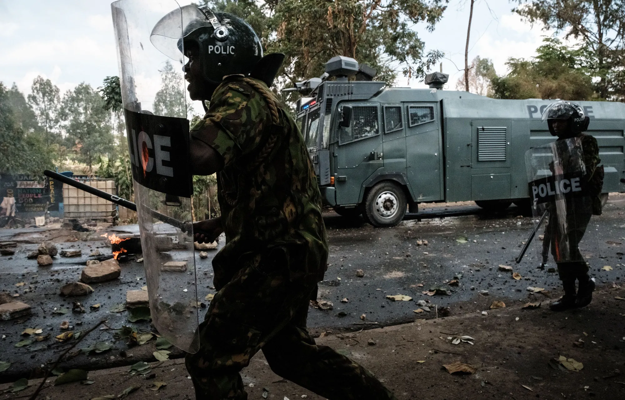 Police officers move toward protesters in Kibera, Nairobi on March 20.