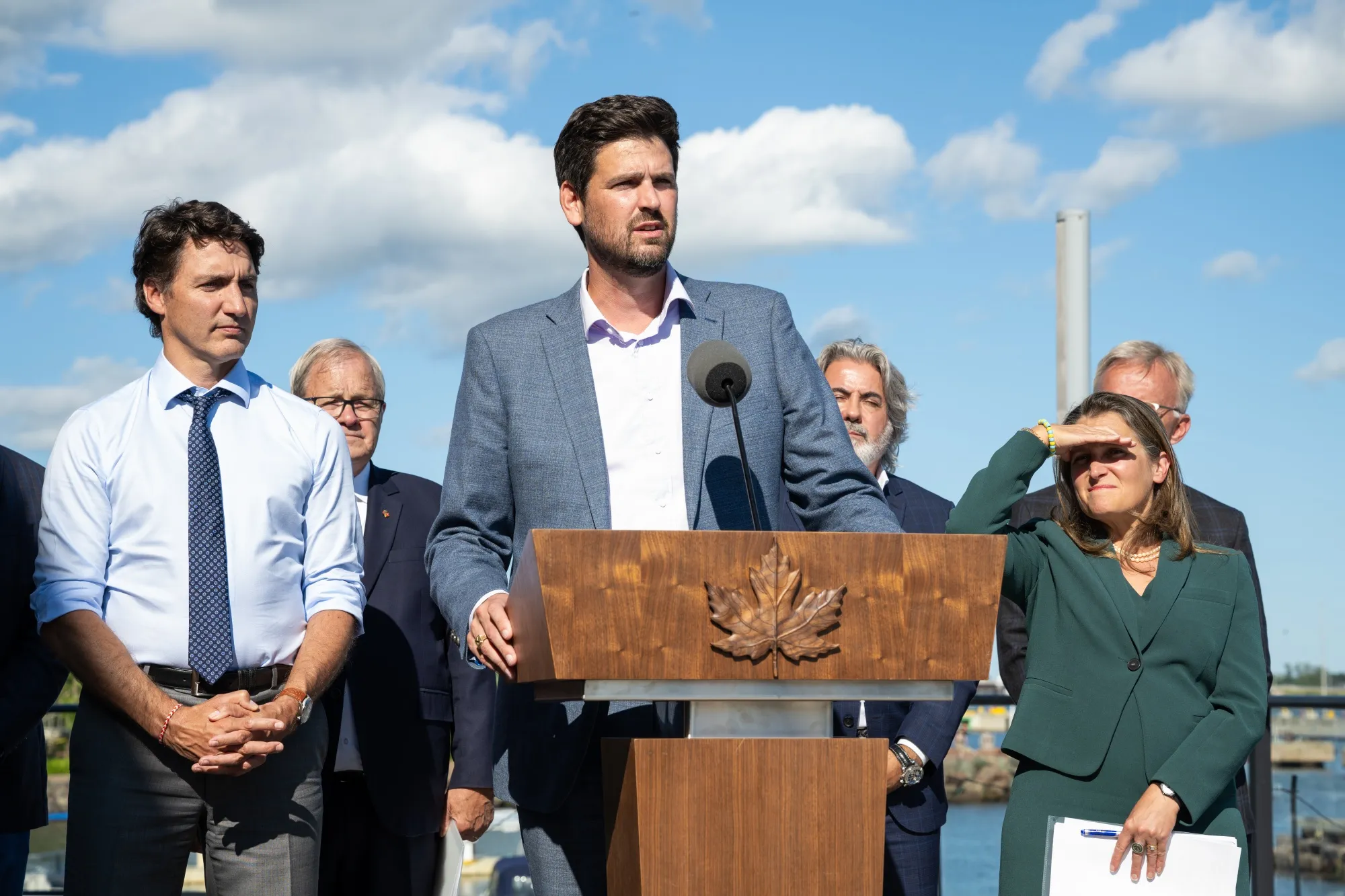 Canadian Housing Minister Sean Fraser, center, with Prime Minister Justin Trudeau, Deputy Prime Minister Chrystia Freeland and other government officials.