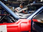 An employee works on a Ford Motor Co. Expedition sports utility vehicle (SUV).