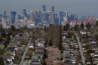 Downtown Vancouver is seen past rows of single family homes.