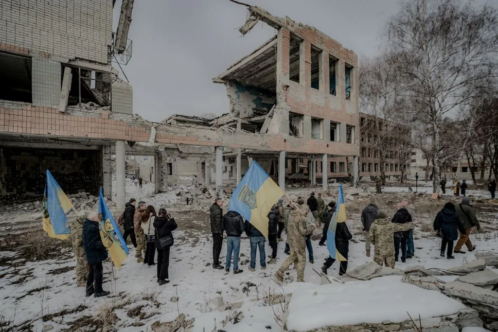Ukrainian soldiers and relatives of fallen soldiers walk with national flags in March to the sites of Russian airstrikes in Kharkiv.&nbsp;