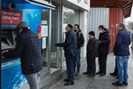 Customers wait to access a Denizbank AG bank branch in the Fatih district of Istanbul.