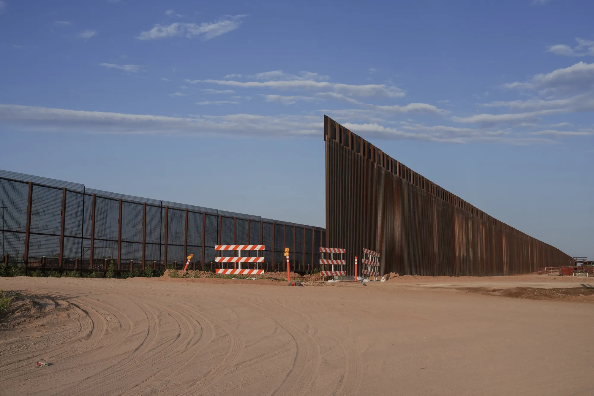 A newly constructed bollard-style border wall, right, on the US-Mexico border in Santa Teresa, New Mexico, in August.