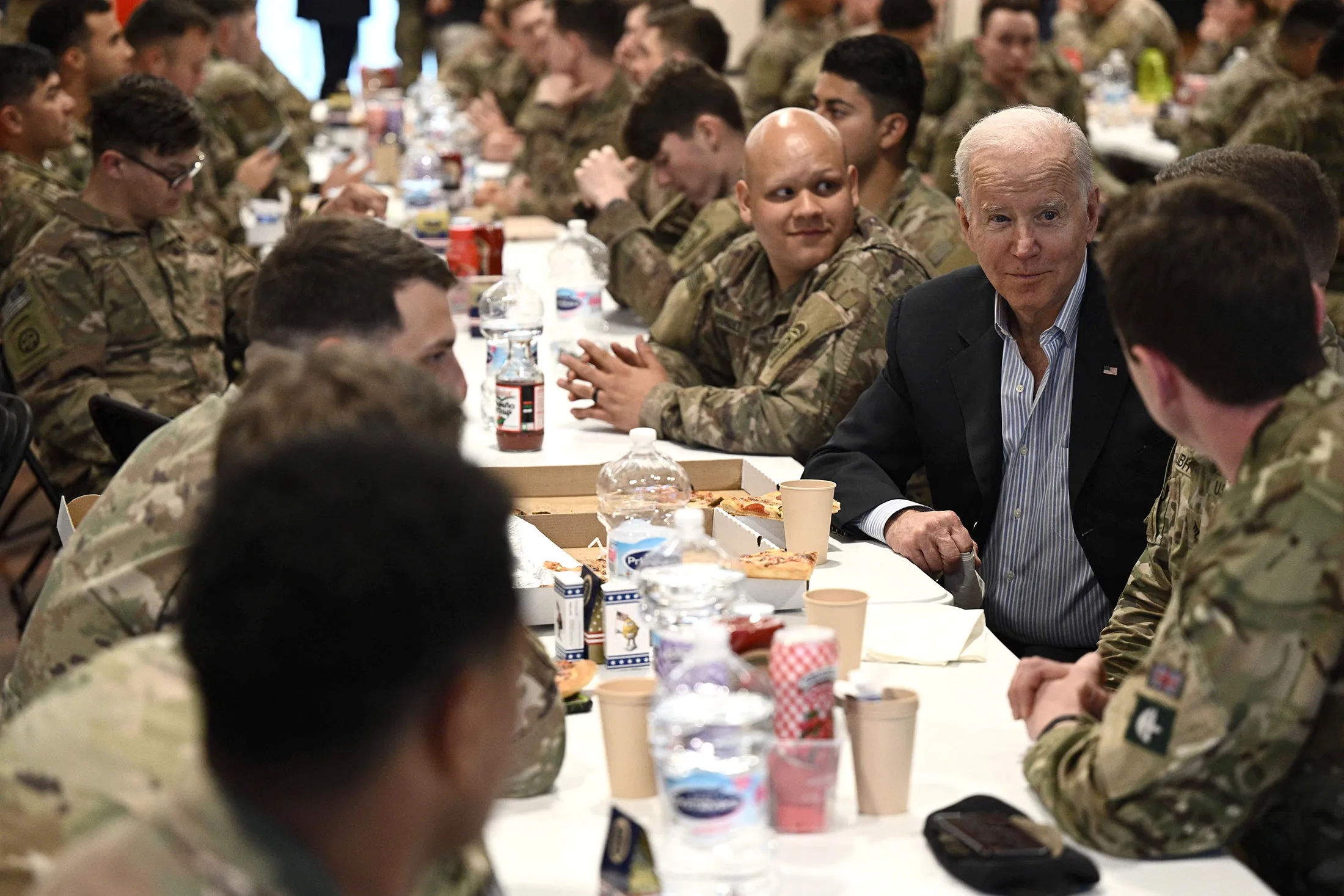 President Joe Biden eats with service members from the 82nd Airborne Division in Rzeszow, Poland, on March 25, 2022.
