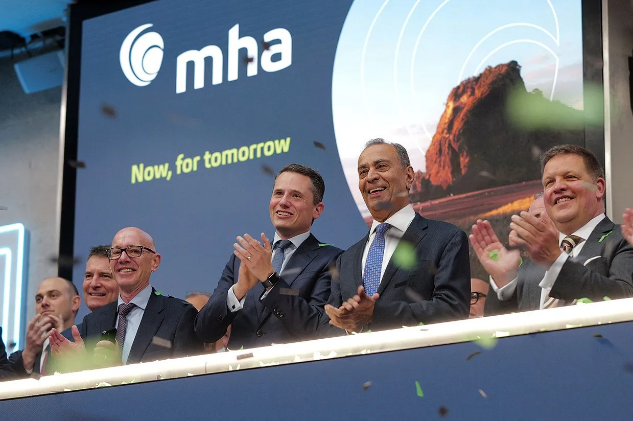 LSE Deputy CEO Charlie Walker, left, and MHA Plc CEO Rakesh Shaunak, right, celebrate the accountancy firm’s IPO on April 15.