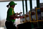An employee delivers food at a Sonic drive-in restaurant in Normal, Ill.