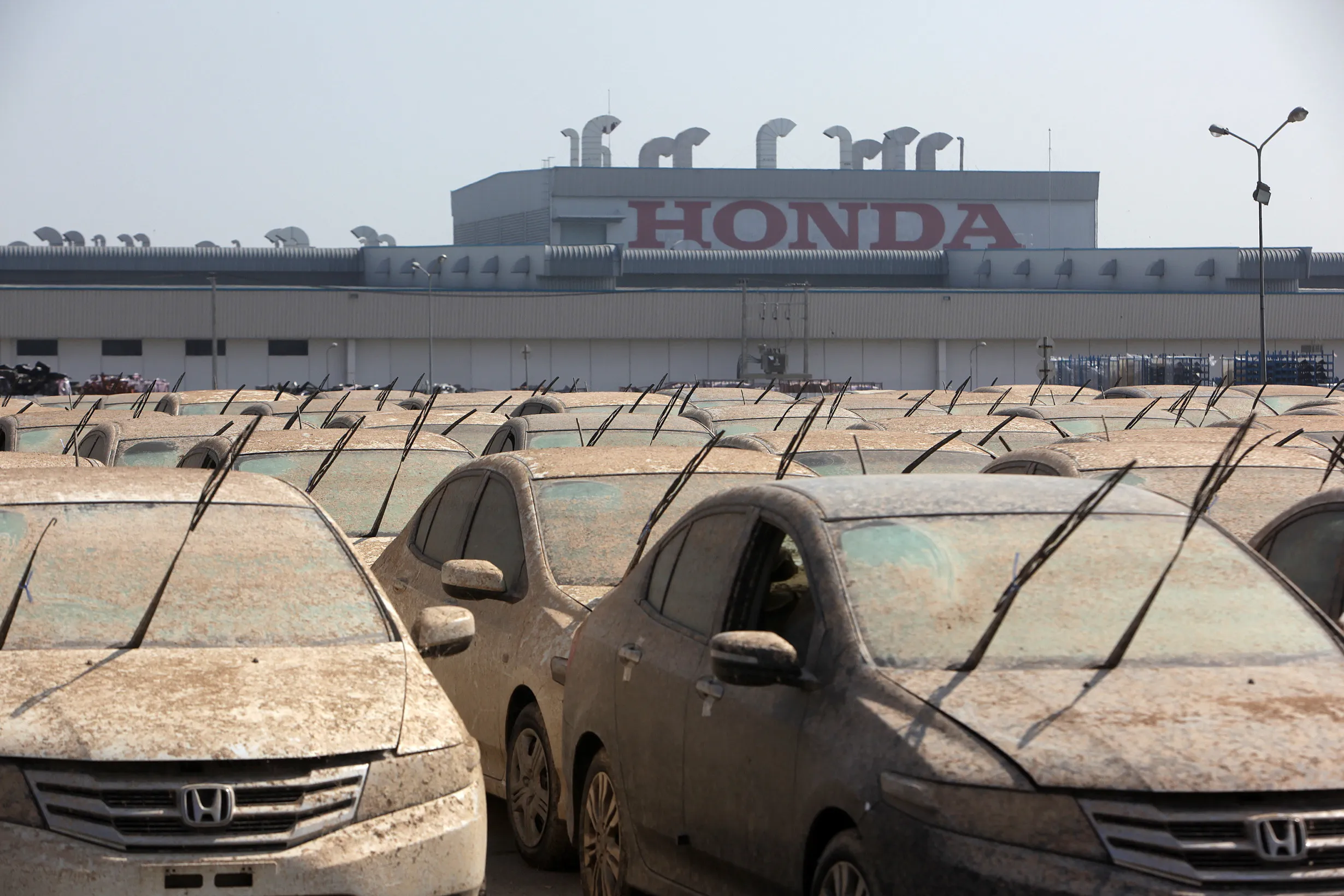 Flood-damaged Honda vehicles outside the company’s plant in Ayutthaya, Thailand, in 2011.