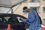 A healthcare worker administers a Covid-19 test at a drive-thru testing site in Sydney on Dec. 16.