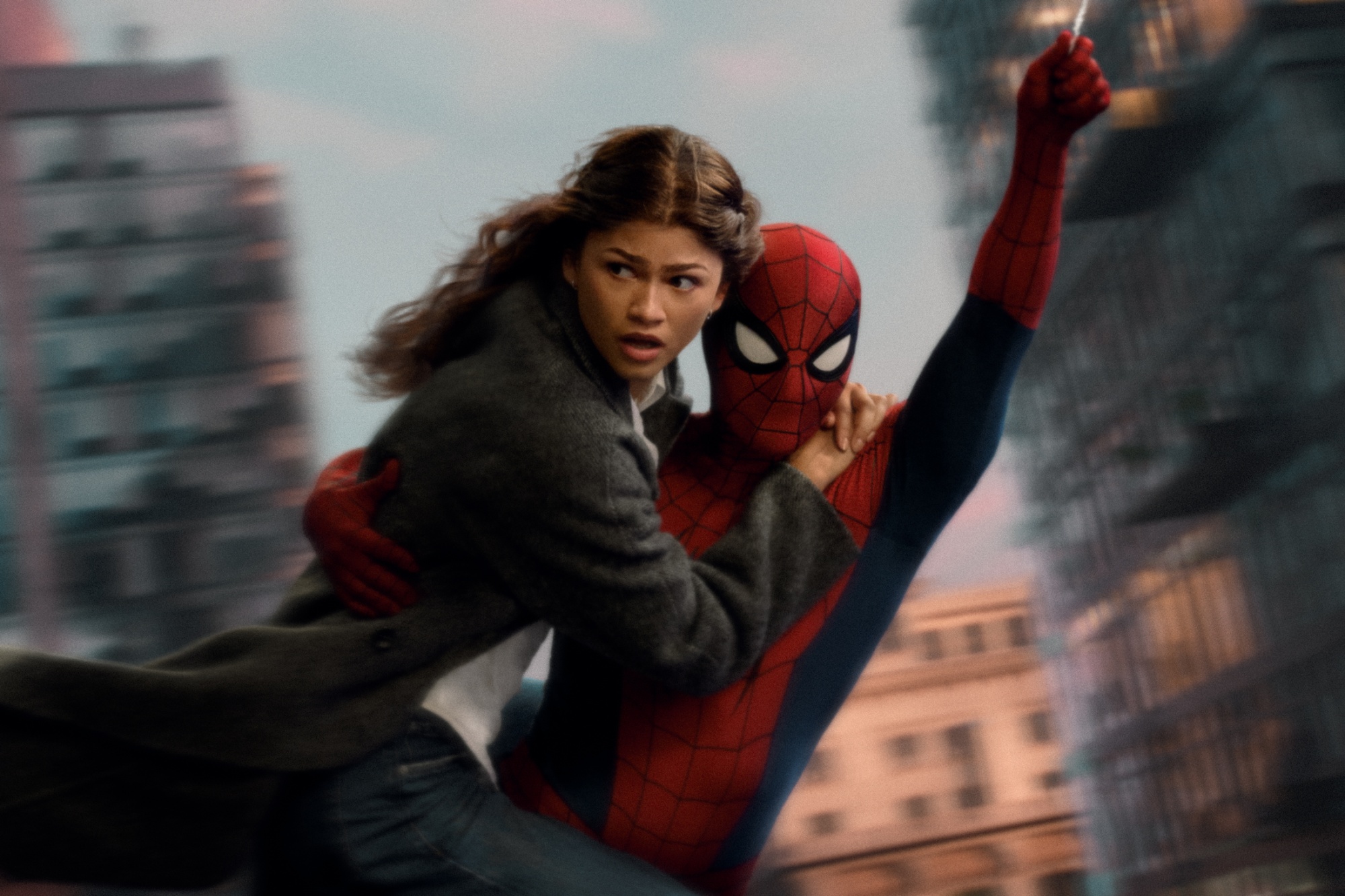 MJ (Zendaya) swings through the city with Spider-Man. Photographer: Jay Maidment