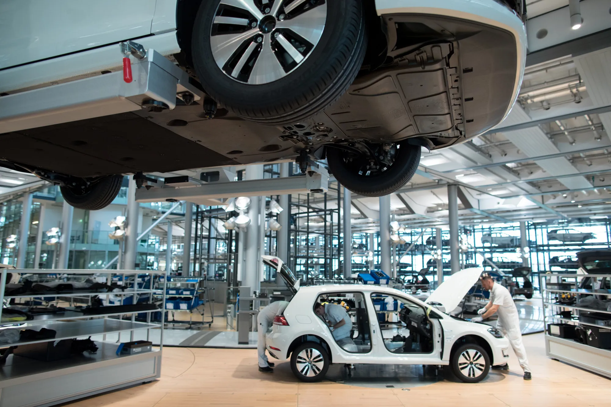 Employees work on a Volkswagen e-Golf electric automobile on the assembly line inside the Volkswagen AG factory in Dresden.