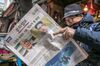 A man reads a copy of the Munhwa Ilbo newspaper featuring U.S. President Donald Trump and North Korean leader Kim Jong-un on the front page in Seoul, South Korea, on Friday, March 9, 2018. Trump hailed “great progress” in talks with North Korea after agreeing to meet Kim in what would be an unprecedented summit.