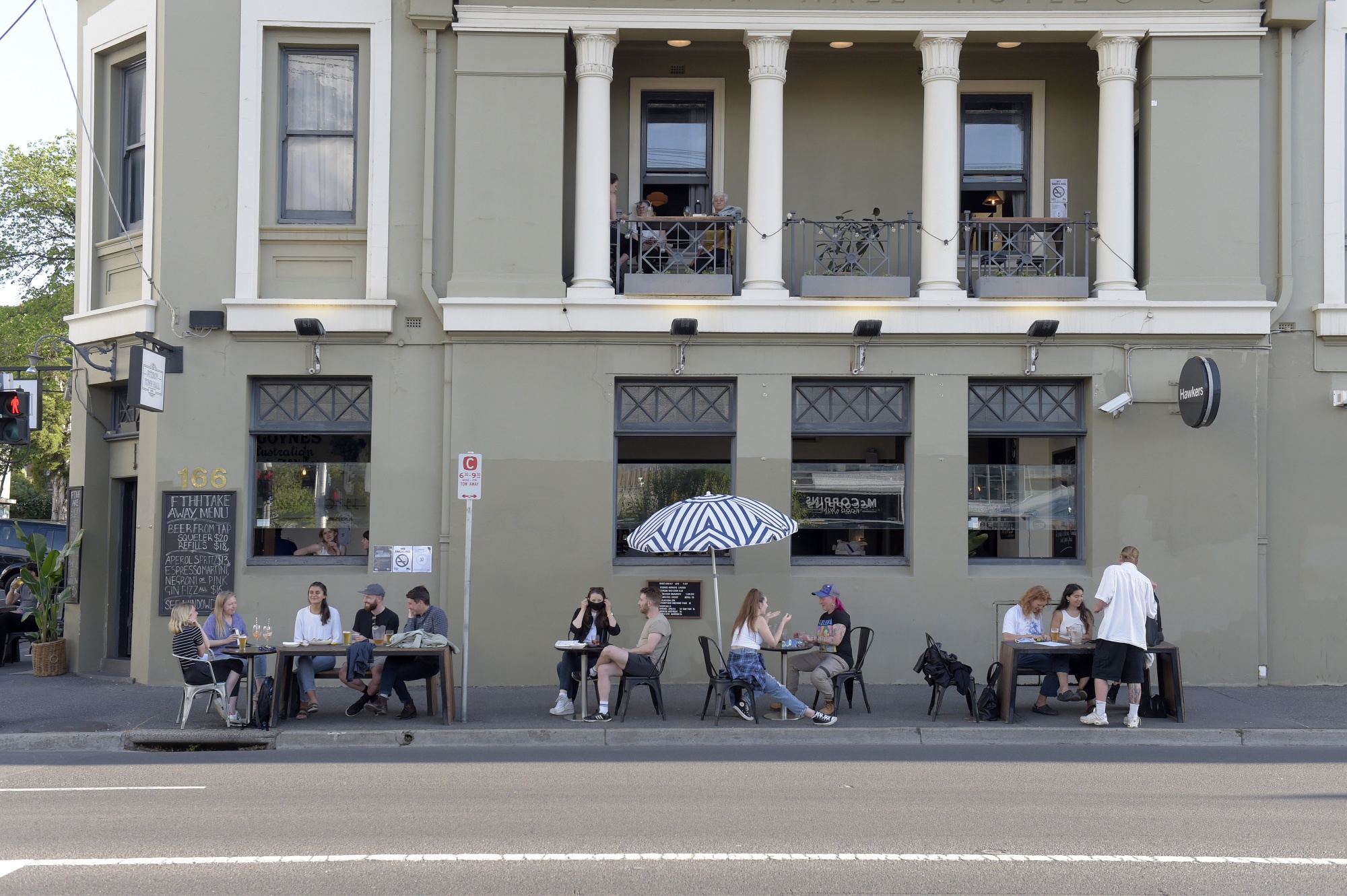 Customers outside of a bar in the Fitzroy district of Melbourne on Oct. 28. The nation’s second-largest city emerged&nbsp;from a three-month lockdown that shuttered business and largely confined residents to their homes.