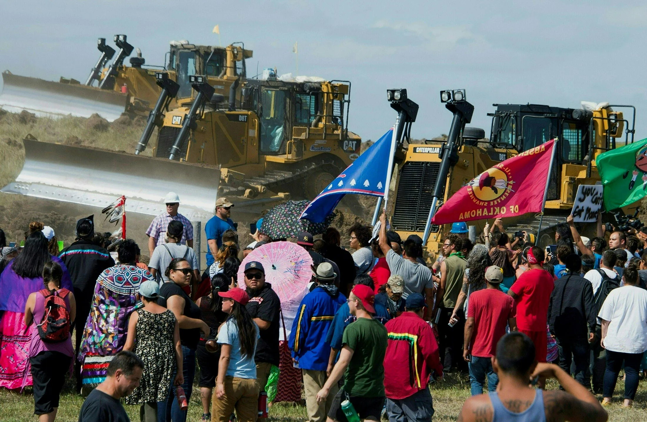 Members of the Standing Rock Sioux Tribe and their supporters opposed to the Dakota Access Pipeline (DAPL) confront bulldozers working on the new oil pipeline in an effort to make them stop, September 3, 2016, near Cannon Ball, North Dakota. / AFP / Robyn BECK / TO GO WITH AFP STORY by Nova SAFO, 'Native Americans united by oil pipeline fight' (Photo credit should read ROBYN BECK/AFP/Getty Images)
