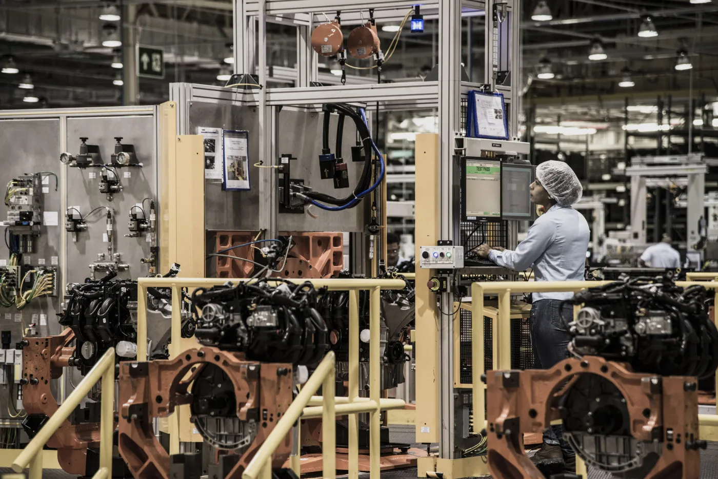 An employee works on the assembly line at an engine manufacturing facility in Brazil.