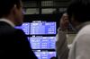 A screen displays the closing price of the Nikkei 225 Stock Average, top, after a ceremony marking the last trading day of the year at the Tokyo Stock Exchange (TSE), operated by Japan Exchange Group Inc. (JPX), in Tokyo, Japan, on Friday, Dec. 28, 2018. Japanese shares fell, with the Topix index capping its worst annual performance since 2011, in a year that saw U.S.-China trade tensions deal a heavy blow to investor sentiment.