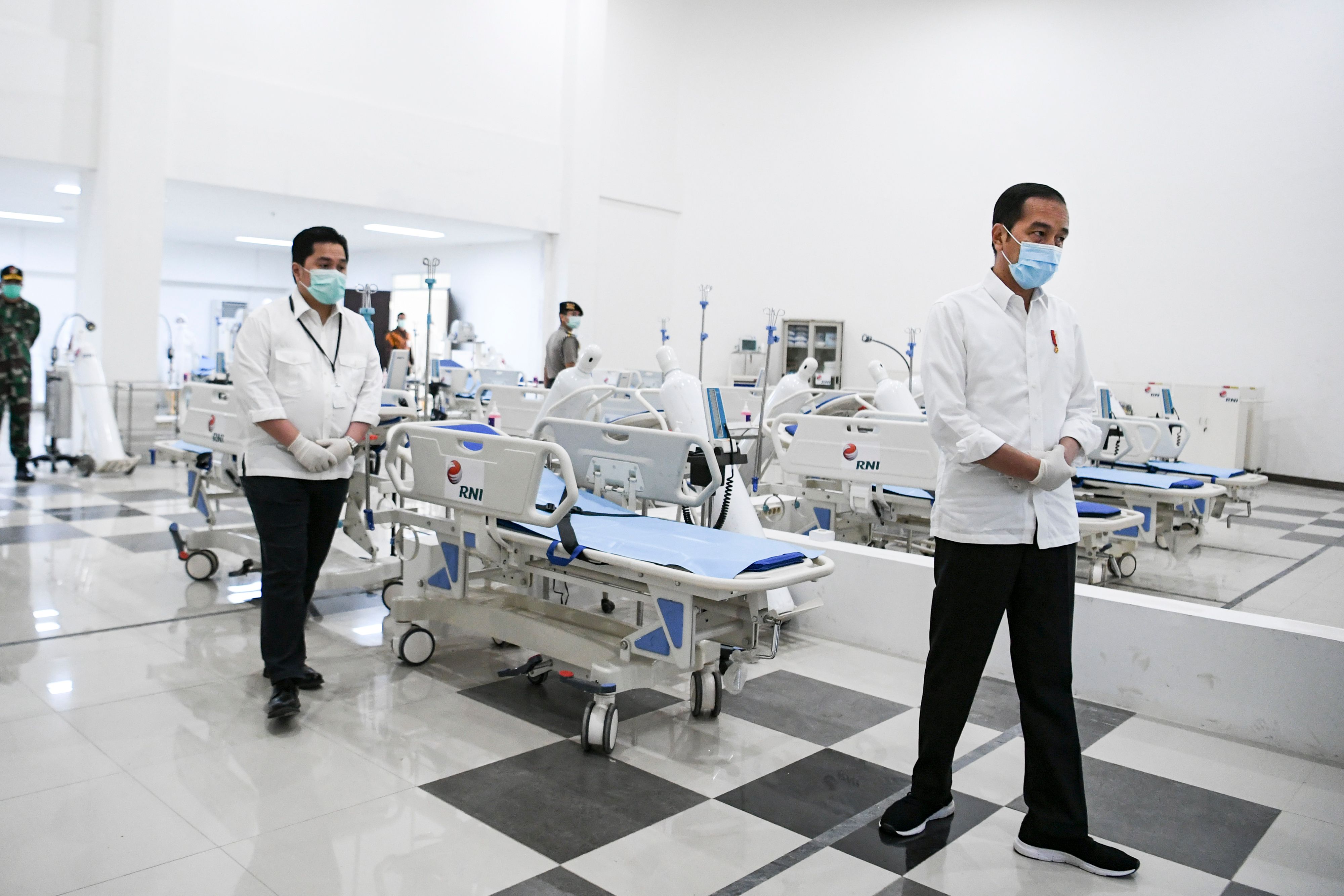 Joko Widodo, right, inspects a room at a hospital for coronavirus patients in Jakarta on March 23.