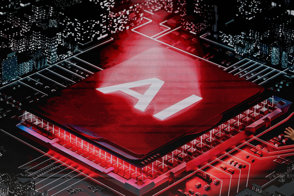 A screen displays an artificial intelligence (AI) processor during Keynote 1 at the MWC (Mobile World Congress), the world's biggest mobile fair, in Barcelona on March 3, 2025. Surrounded by investment and innovation projects, the Mobile World Congress (MWC) kicks off today in Barcelona amid a context of euphoria but also tensions over artificial intelligence (AI), whose rapid advancement is shaking up the tech sector. (Photo by LLUIS GENE / AFP) (Photo by LLUIS GENE/AFP via Getty Images)