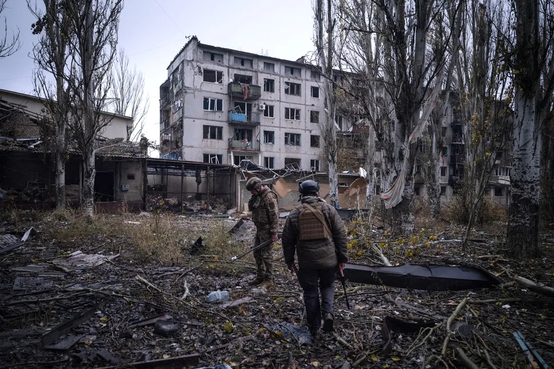 Ukrainian servicemen checking the area next to destroyed buildings in the frontline town of Kostyantynivka, Donetsk region, in a handout photograph from the 93rd Kholodnyi Yar Separate Mechanized Brigade of the Ukrainian Ground Forces, on Nov. 12, 2025.