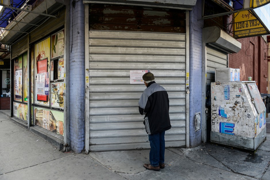 A man pauses in front of a bodega closed as part of a workers' strike in New York City.