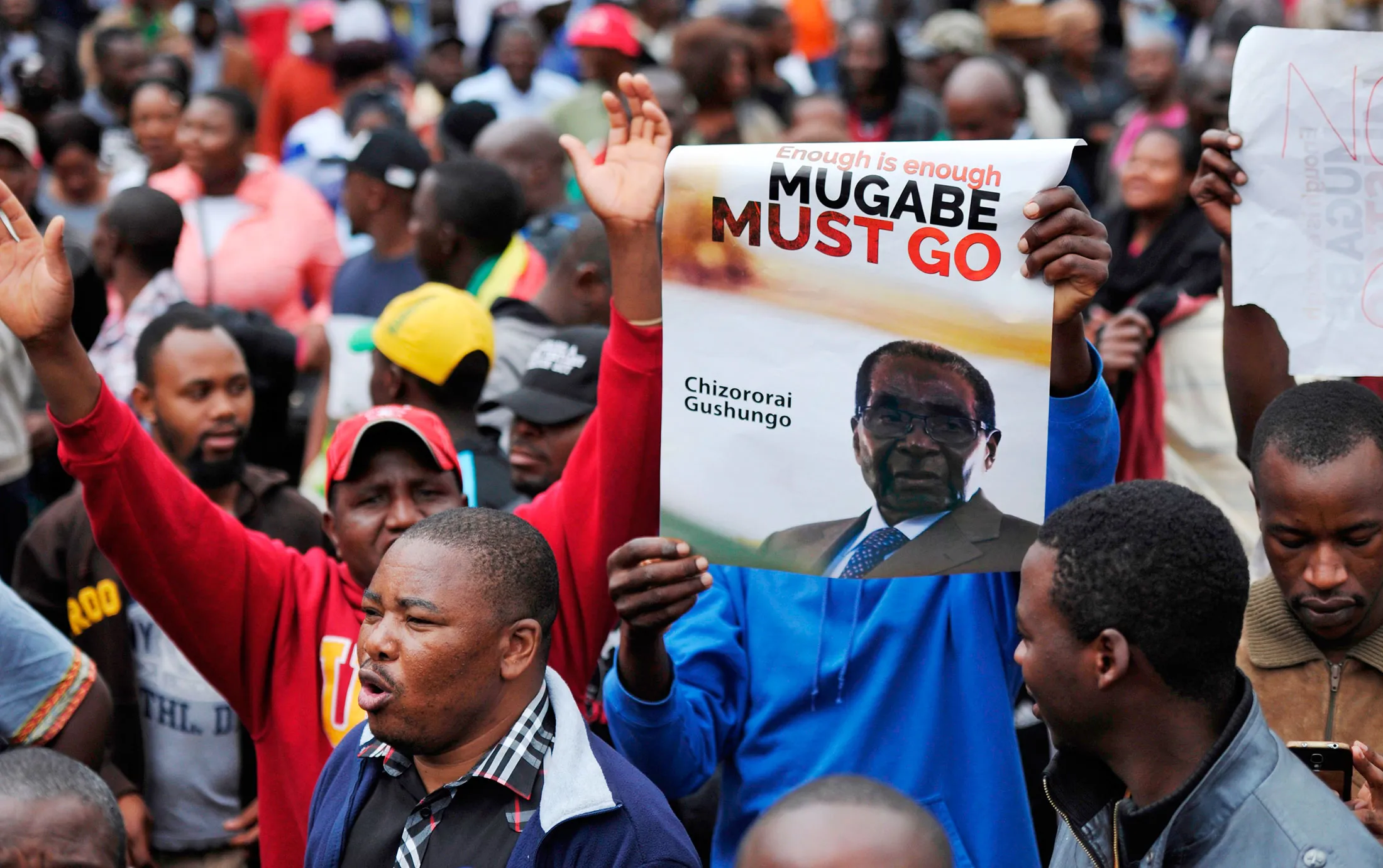 Demonstrators hold anti-Mugabe placards and shout slogans during a protest march demanding the resignation of Zimbabwe's president on Nov.&nbsp;18.&nbsp;