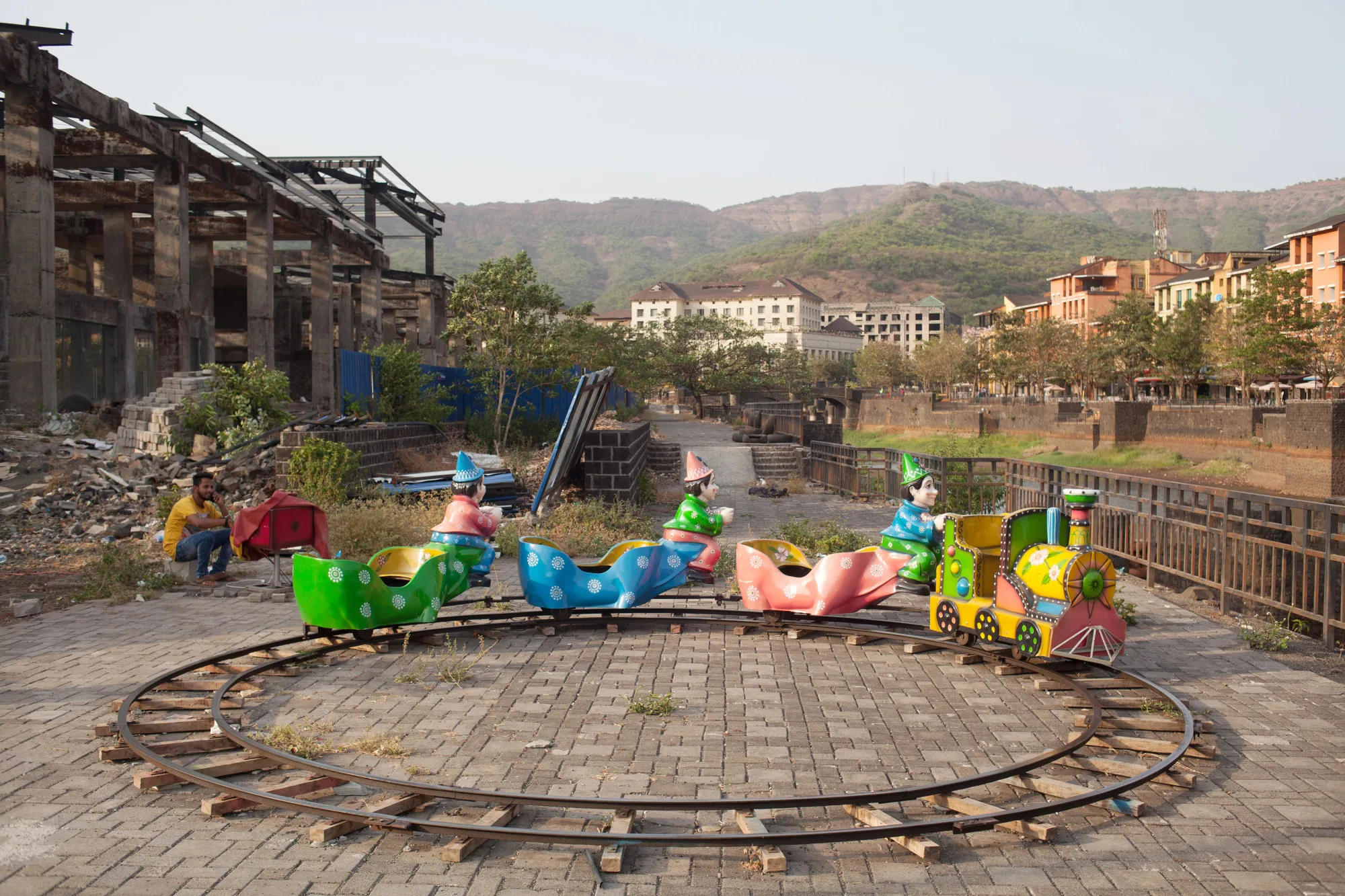 Skeletons of half-finished buildings loom over daily life in Lavasa, India.