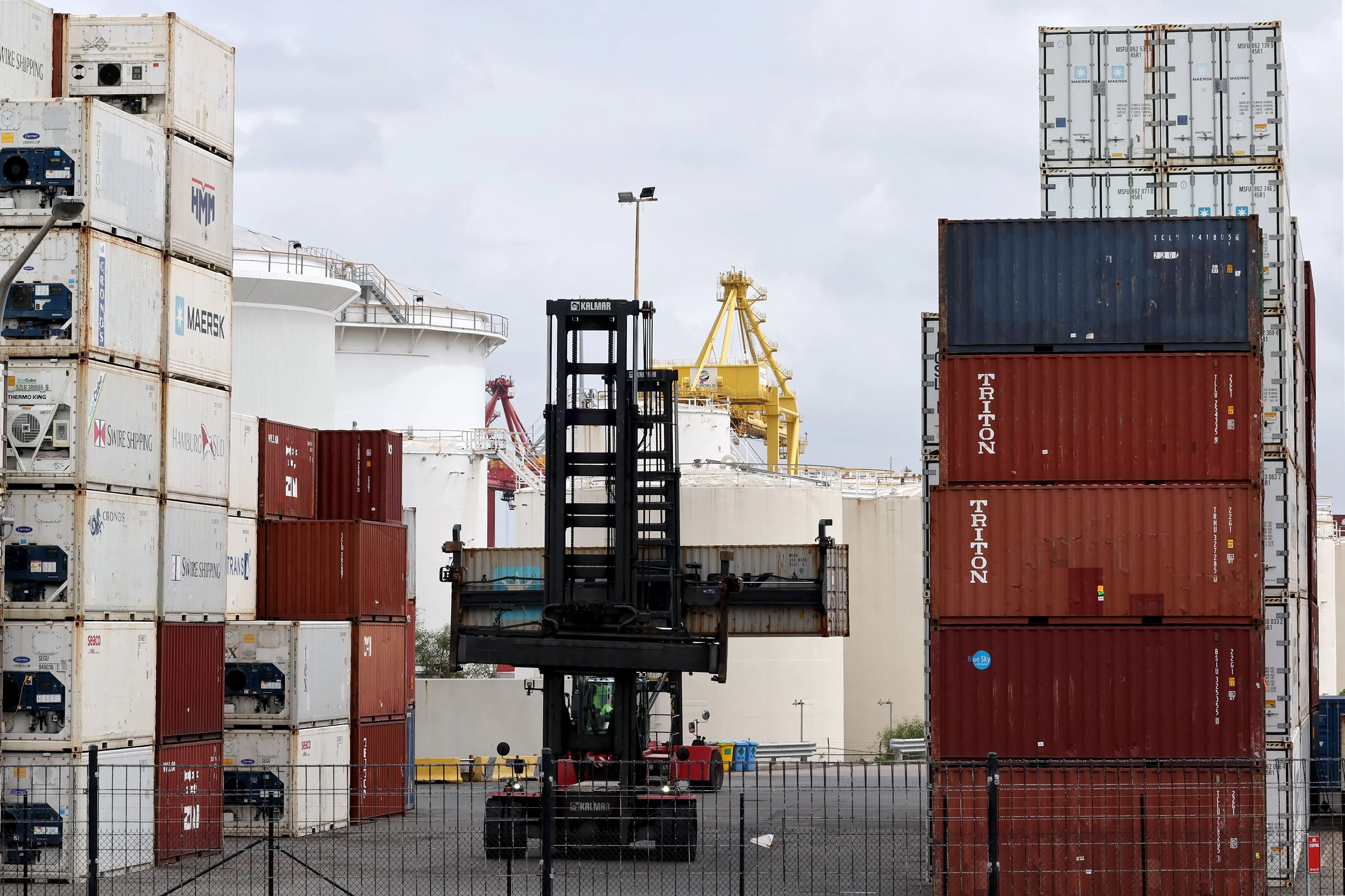 A worker moves containers at the compound of ports operator DP World at Port Botany in Sydney on November 13, 2023.