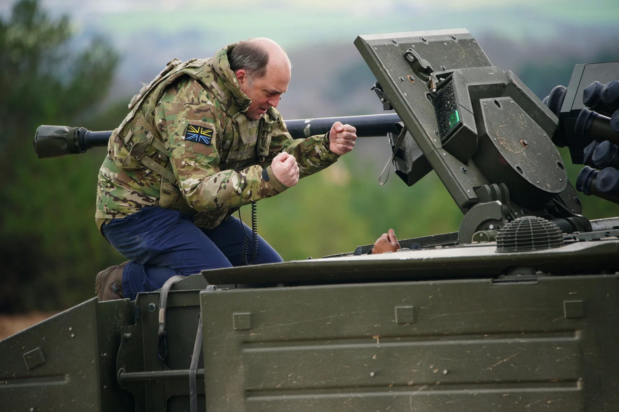 Ben Wallace is given a demonstration of an Ajax Ares Armoured Fighting Vehicle, by the crew on the training range at Bovington Camp, in&nbsp;England, on Feb. 22.