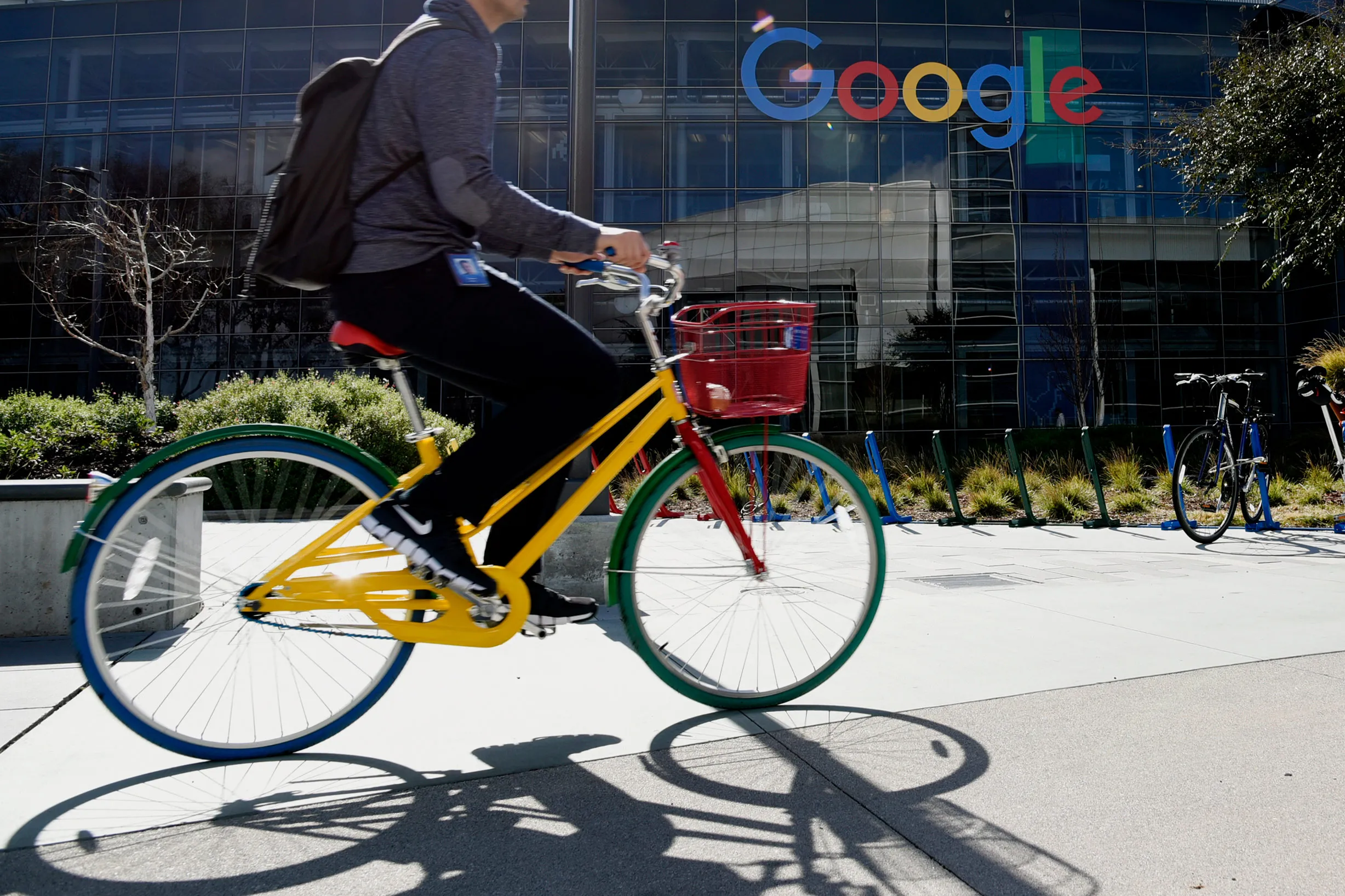 An employee passes the Google Inc. offices in Mountain View, California.