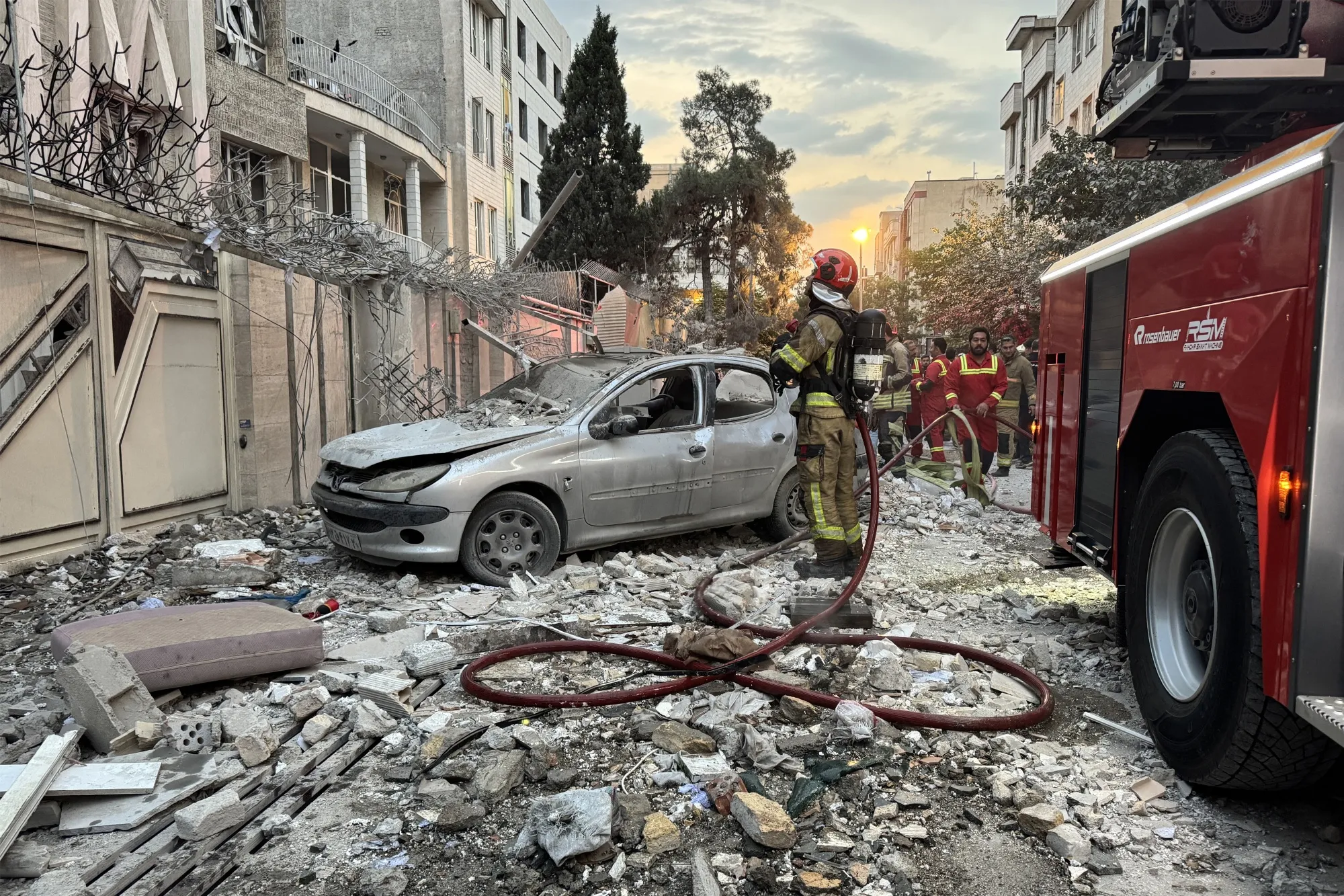 First responders at the site of an Israeli strike in Tehran on June 13.