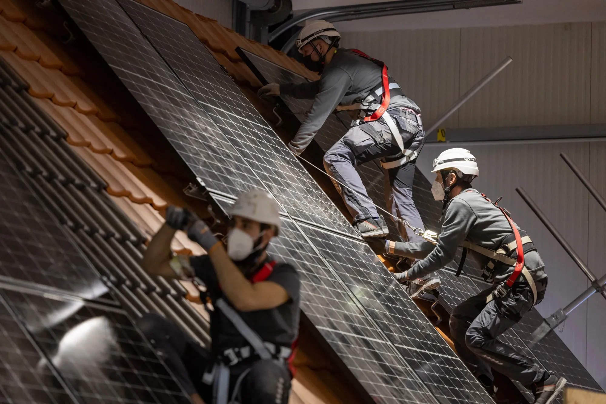 Enpal trainees install solar panels at a training facility in Blankenfelde-Mahlow, Germany.