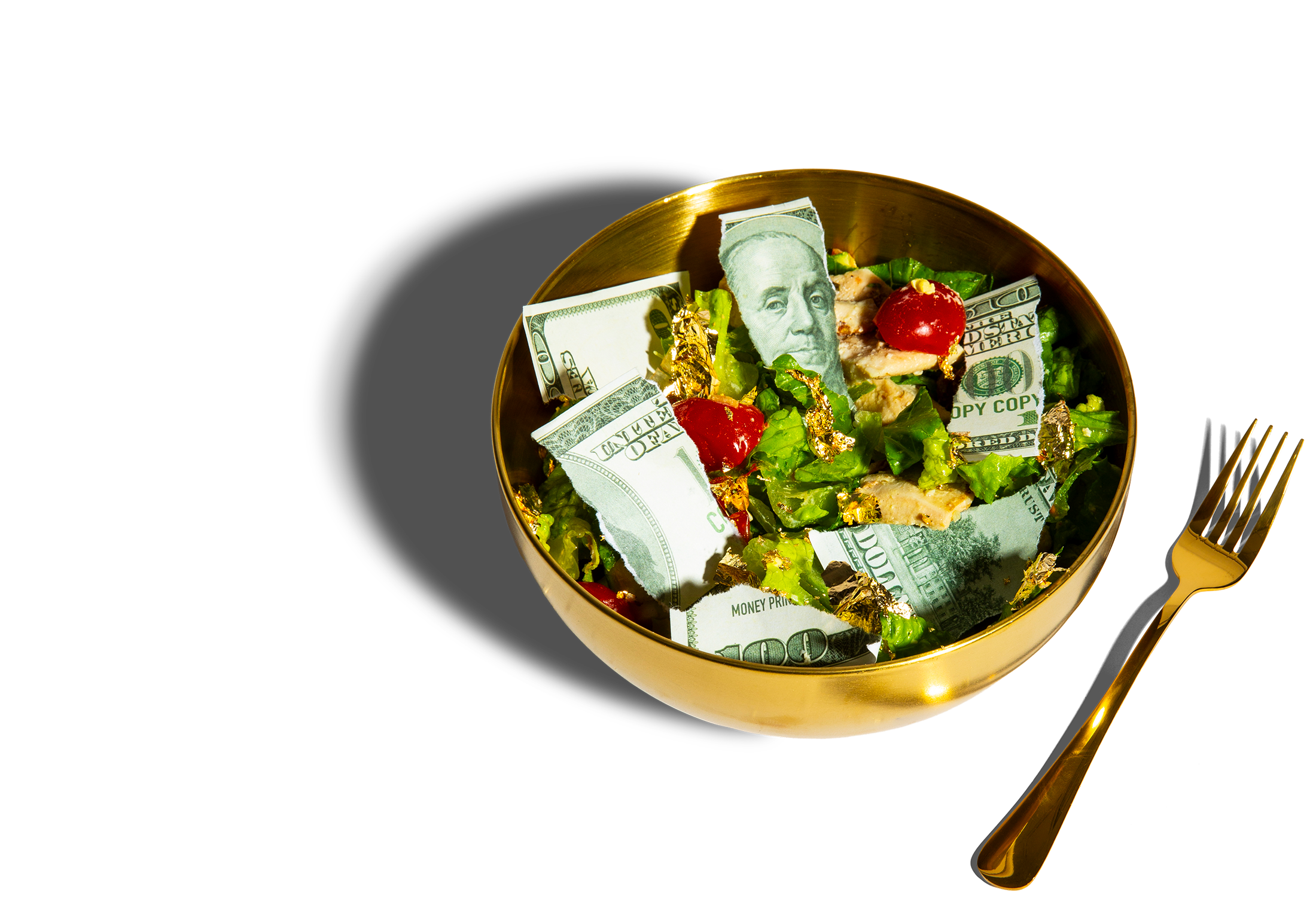 Photo illustration showing a ripped-up $100 bill atop a salad in a golden bowl next to a golden fork.
