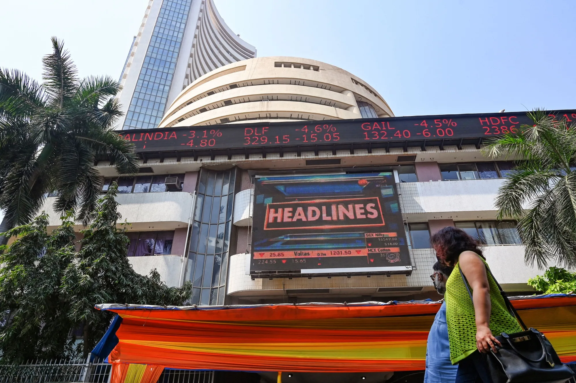 People walk past a digital&nbsp;screen outside the Bombay Stock Exchange&nbsp;in Mumbai, India, on Feb. 24.