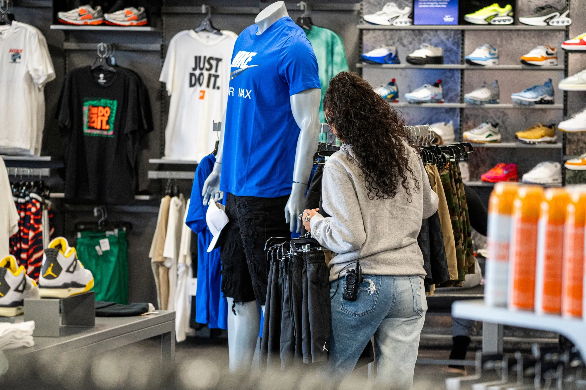 An employee arranges merchandise at a store in Richmond, California.