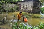 A woman fills drinking water from a tube well in the flood affected village in Nalbari district, Assam state, on June 24.