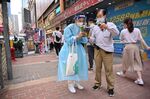 A woman promotes Covid-19 testing kits in the Mongkok area of Hong Kong, on March 19.