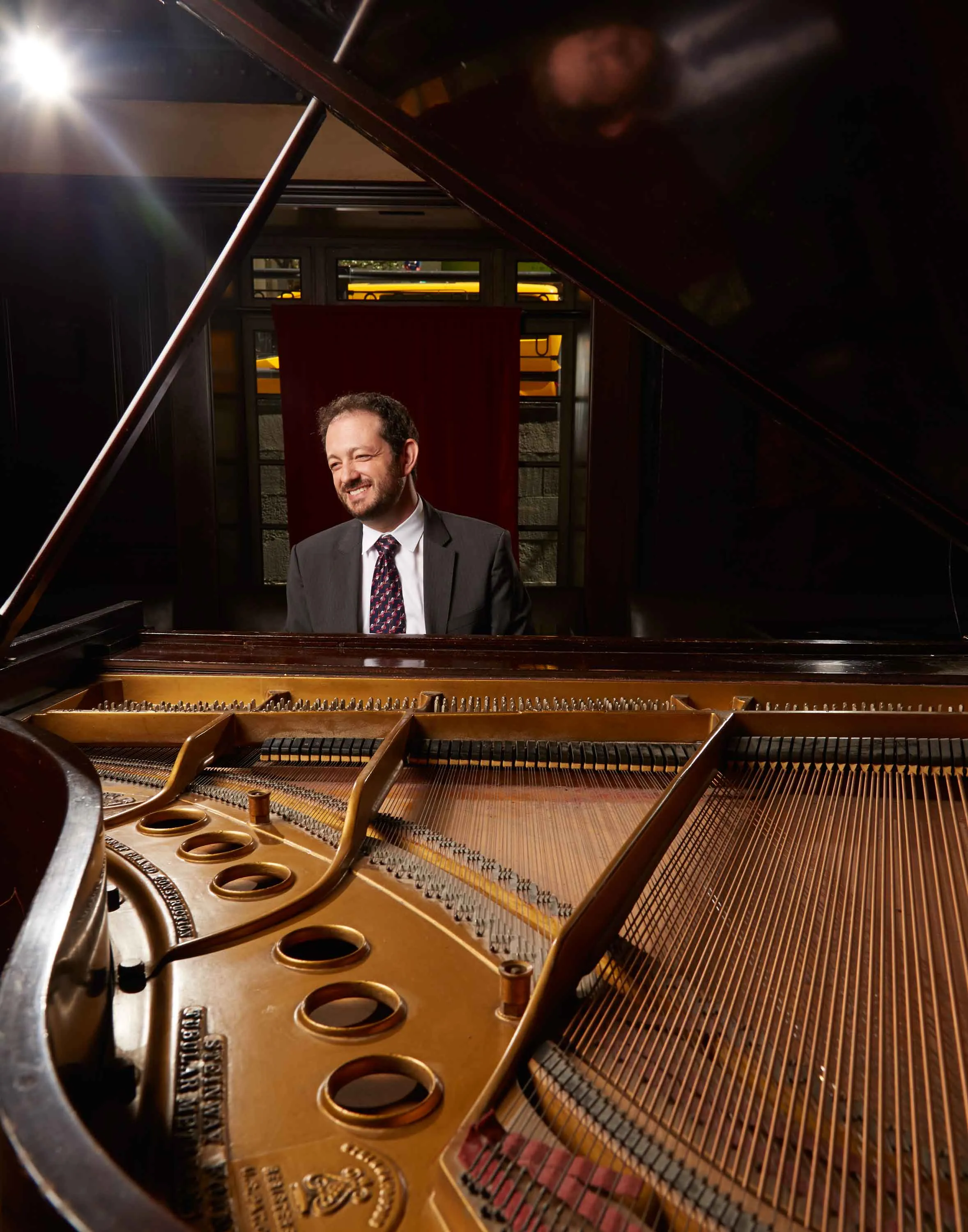 Adrian Banner tries out the piano at the Carlton Hotel in New York.
