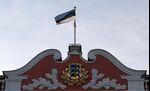 The Estonian nation flag flies at the top of the parliament building in Tallinn.