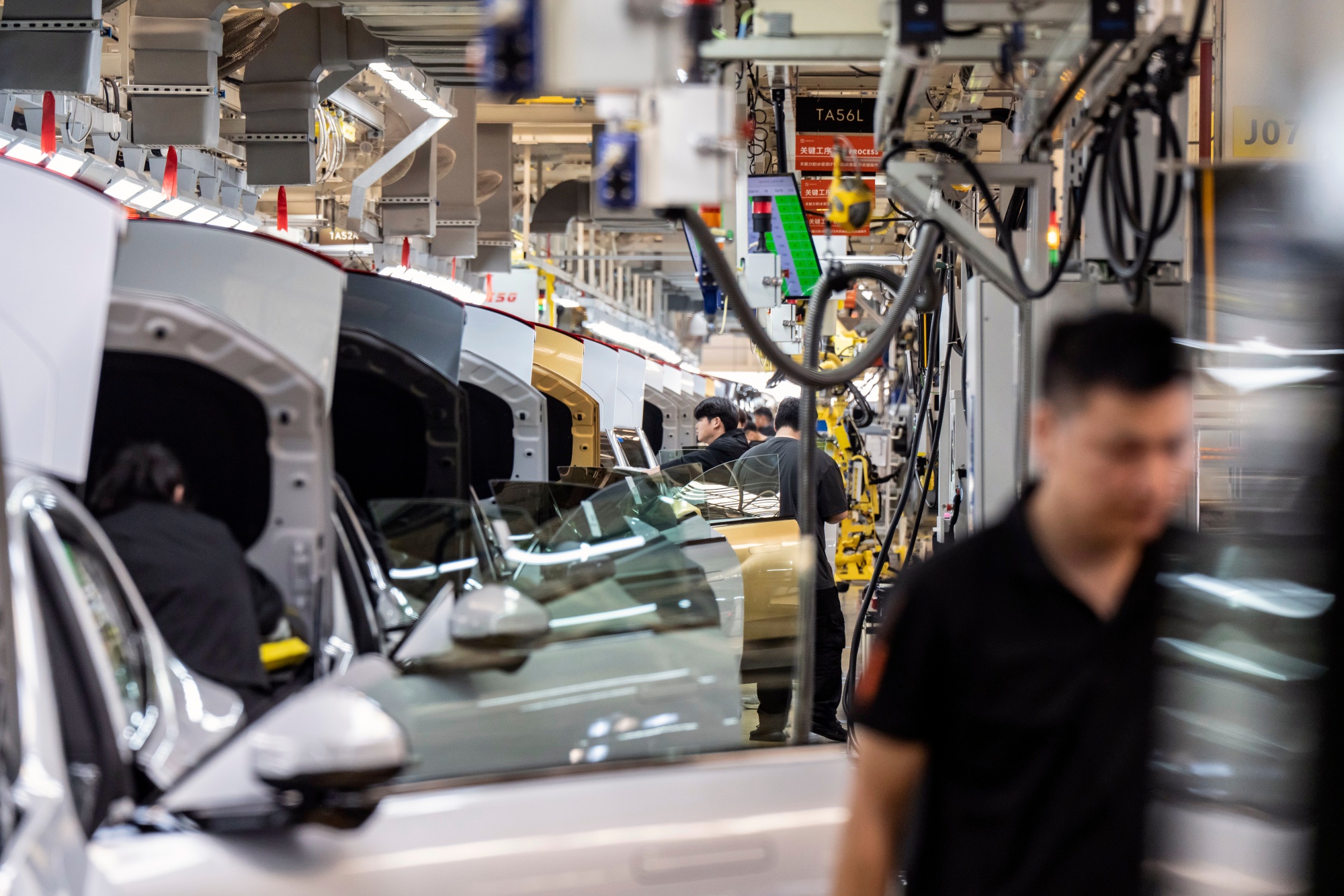 Employees on a production line for Polestar 4 electric vehicles at the Zeekr Group Intelligent Factory in Ningbo, China, on Tuesday, April 29, 2025. Geely Automobile Holdings Ltd., China's fourth-ranked carmaker by market share, said last month that its AI-powered pilot system will be added to all of its brands, including Galaxy, Zeekr and Lynk&Co. Photographer: Qilai Shen/Bloomberg