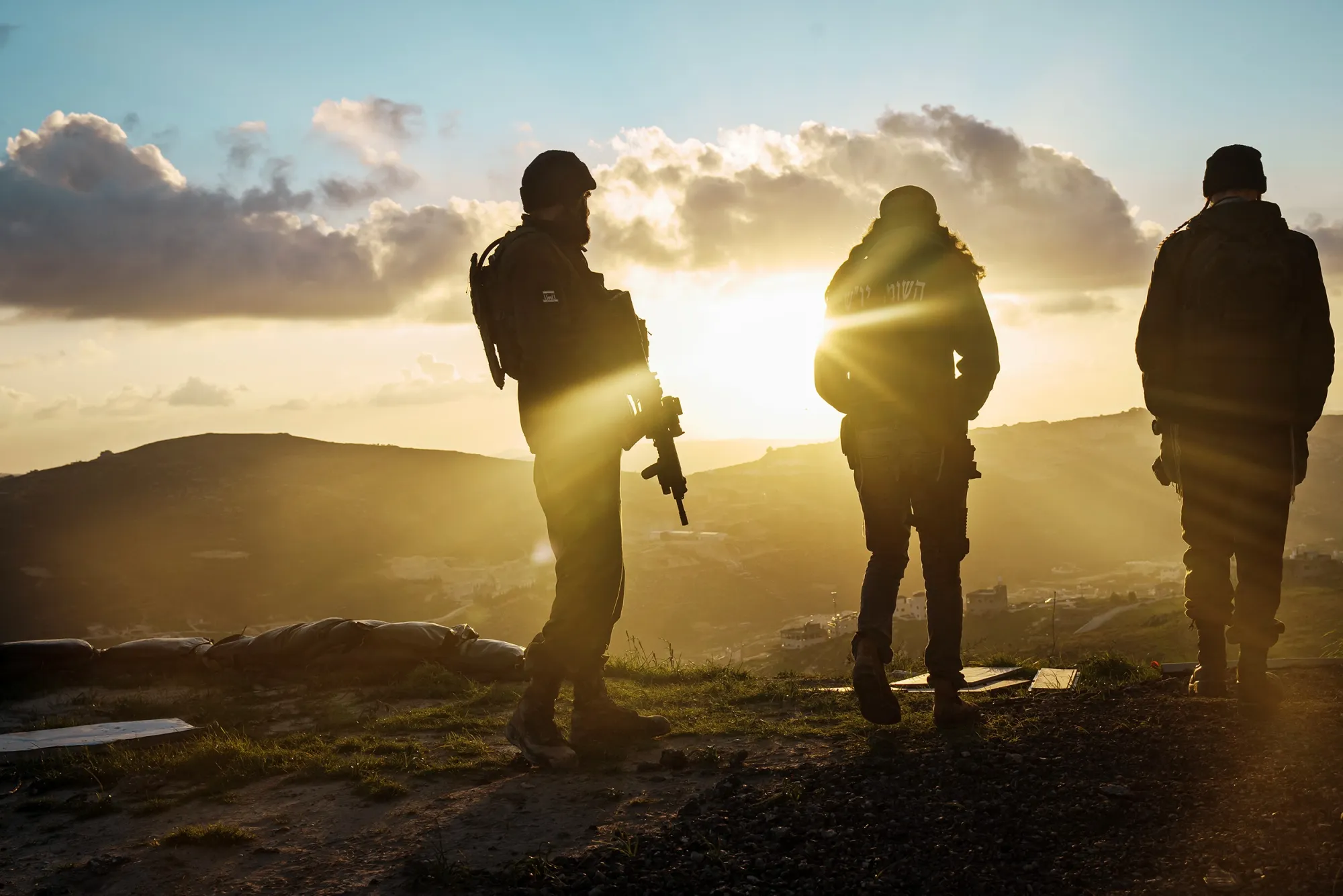 Israeli settlers monitor nearby Palestinian towns from their security outpost at Yitzhar in the West Bank on Feb. 6.