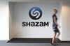 An employee walks through the lobby of the Shazam Entertainment Ltd. headquarters in London, U.K., on Friday, July 26, 2013. Billionaire Carlos Slim's America Movil SAB has invested $40 million in the London-based company behind the software with more than 70 million active users every month.