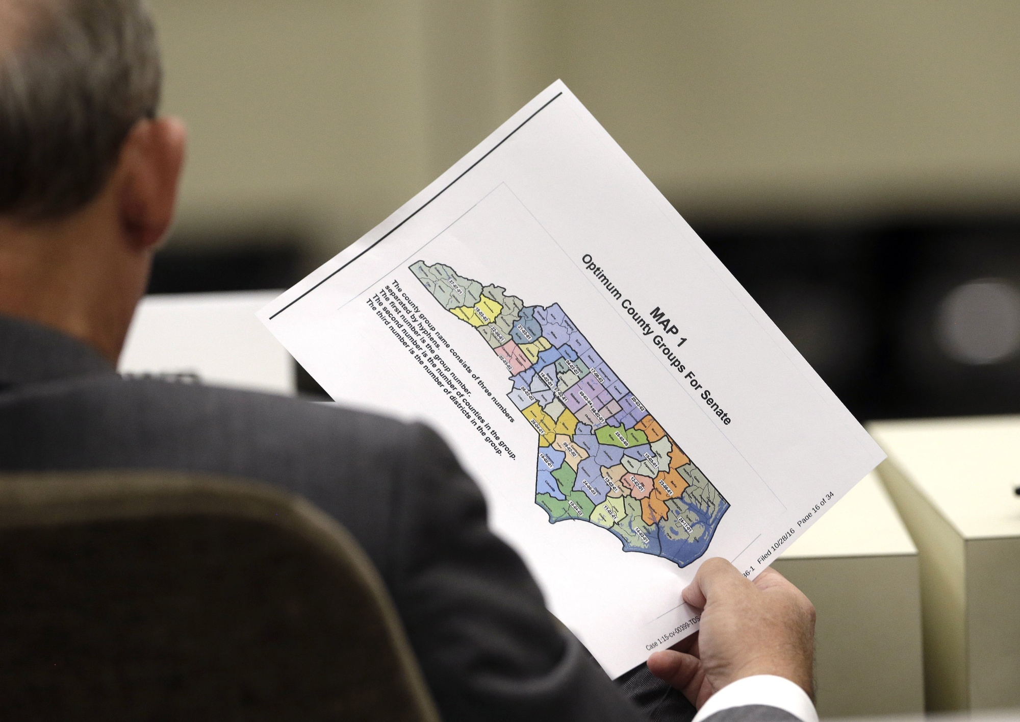 A lawmaker holds a districting map in Raleigh, NC.