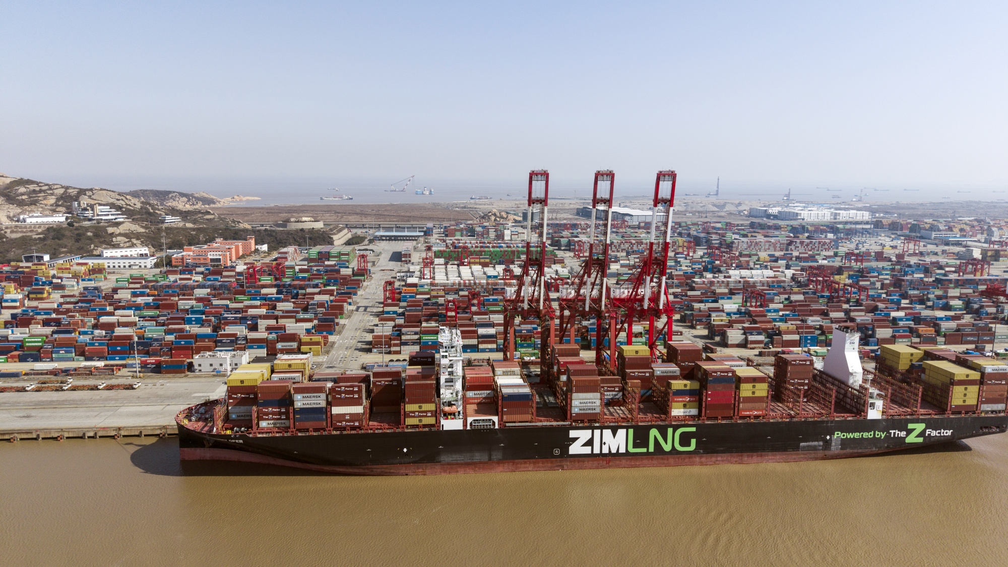 The ZIM Integrated Shipping Services Ltd. Sammy Ofer liquefied Natural Gas (LNG) container ship docked at the Yangshan Deepwater Port in Shanghai, China, on Monday, Feb. 10, 2025. President Donald Trump plans to impose 25% tariffs on all imports of steel and aluminum into the US, broadening his trade salvo and threatening ties with some of the country's top trading partners.