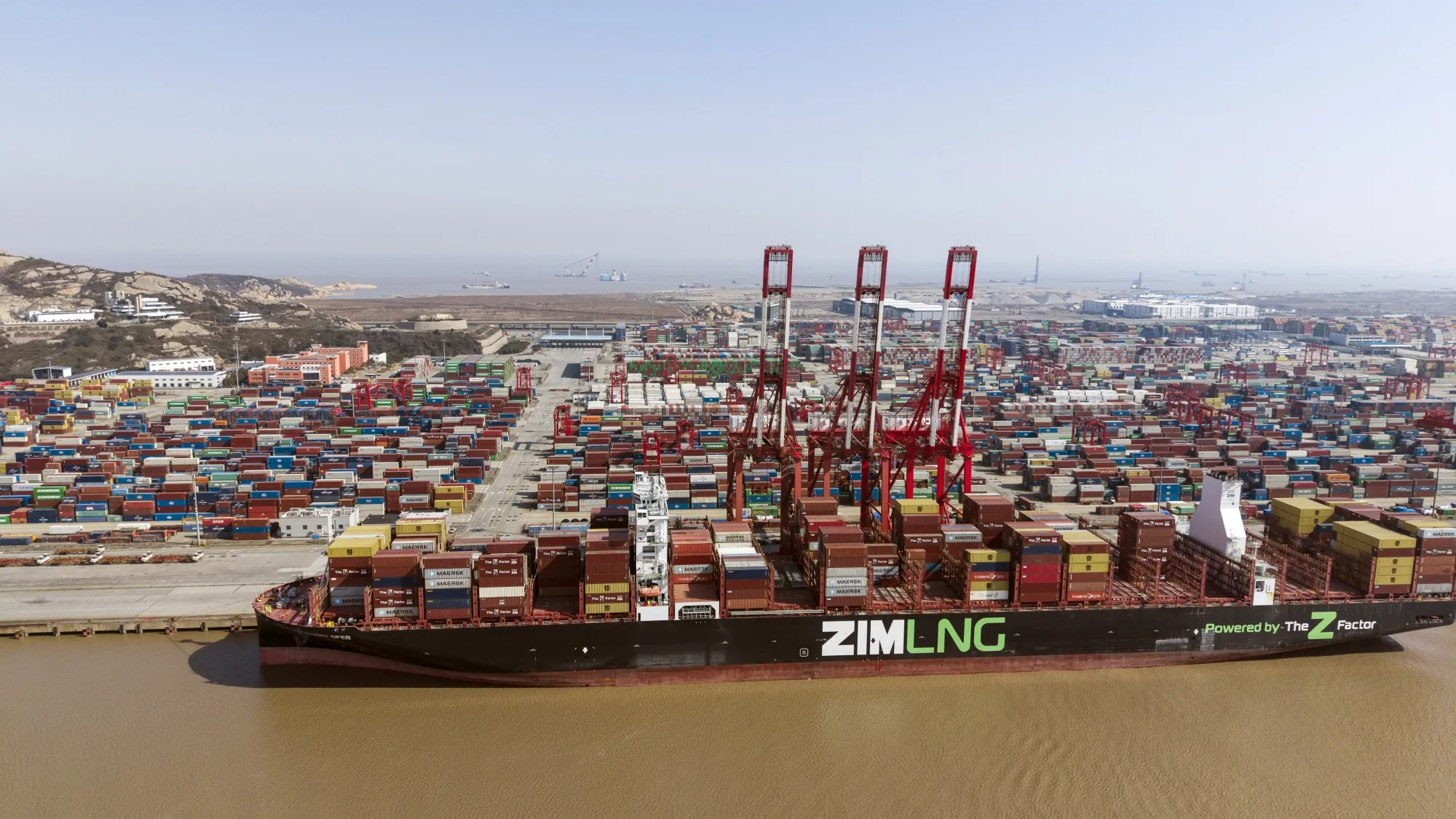 A ZIM Integrated Shipping Services Ltd. LNG container ship docked at the Yangshan Deepwater Port in Shanghai.