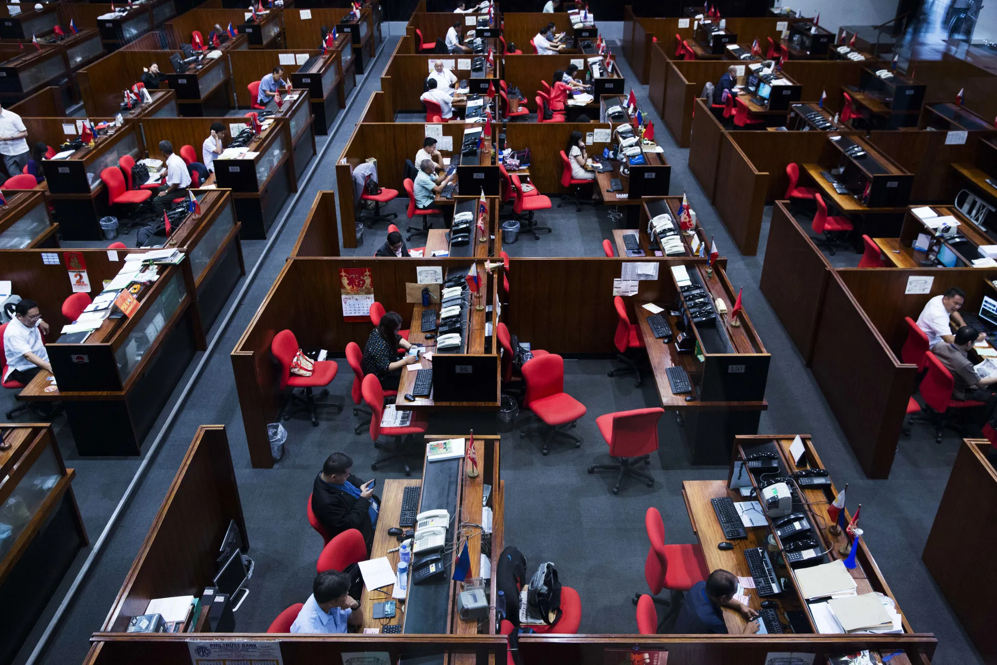 Traders work on the floor of the Philippine Stock Exchange in the Makati district of Manila, the Philippines, on Monday, May 2, 2016.