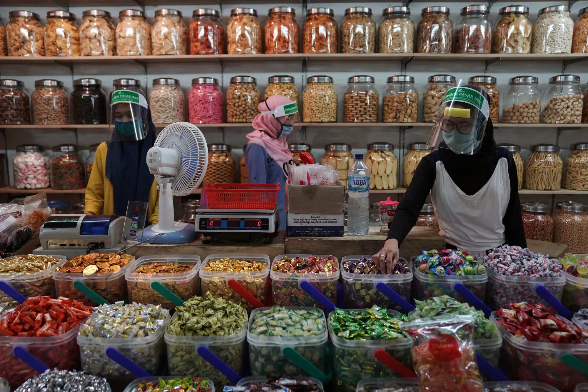 Vendors handle sweets and snacks in a store inside the Pasar Senen market in Jakarta, Indonesia, on July 8.
