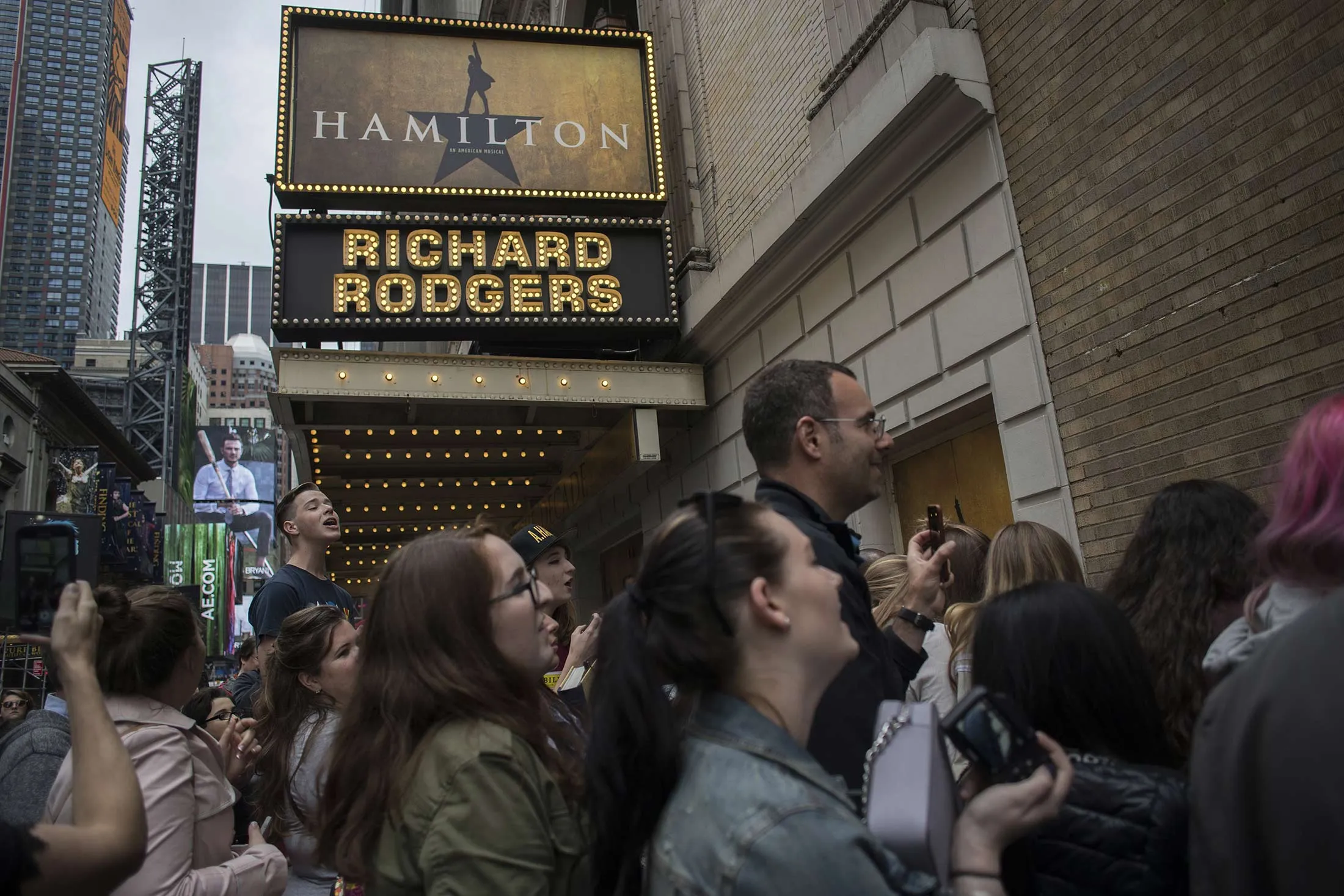 The 'Hamilton' musical signage hangs as attendees gather outside of the Richard Rodgers Theatre in the Times Square area of New York, U.S., on Sunday, May 22, 2016.
