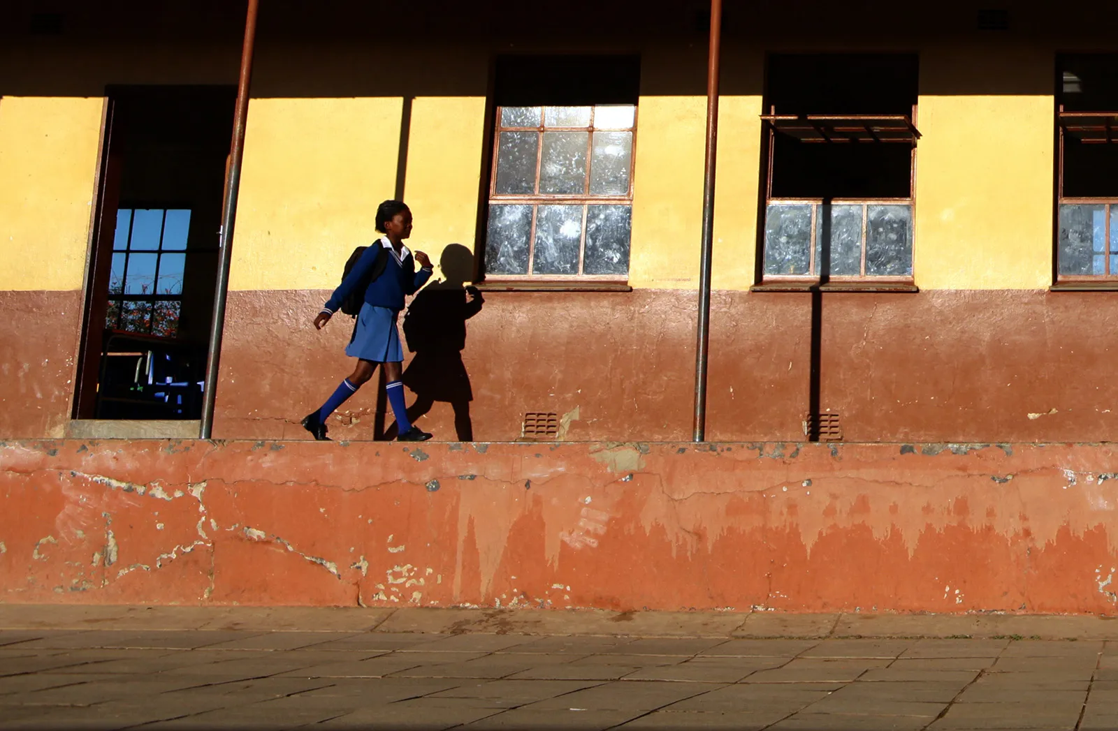 A girls walks to her classroom at the Qunu Junior Secondary School, a village outside the town of Mthatha, South Africa.
